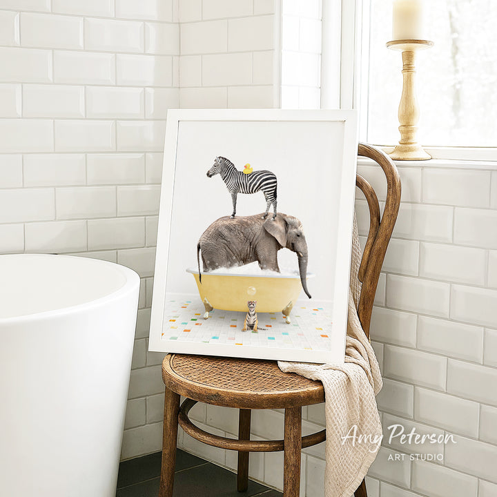 A framed image of a zebra standing on an elephant's back while both animals are in a yellow bathtub, surrounded by colorful tiles.