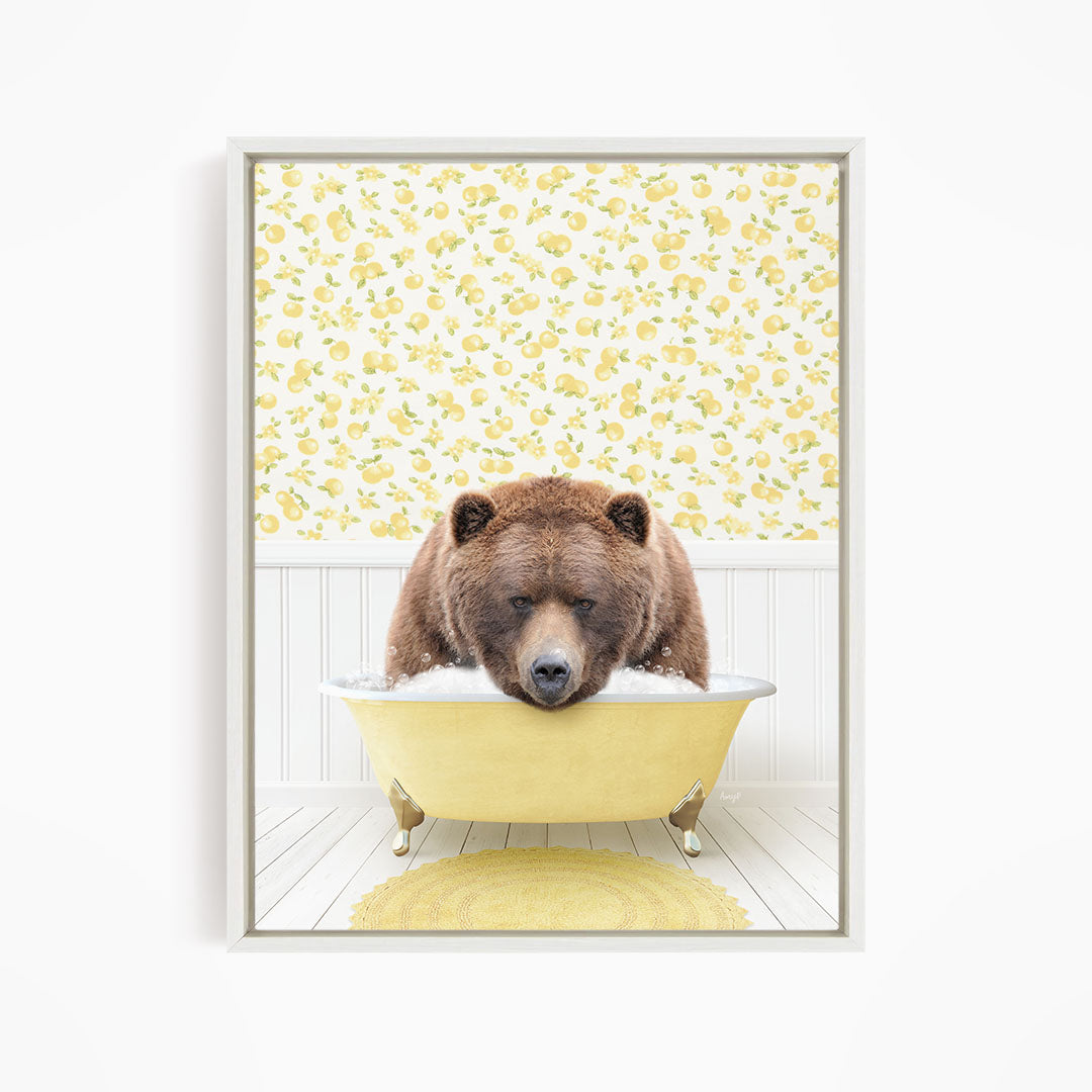 A brown bear is sitting in a yellow bathtub, surrounded by a yellow floral pattern on the wall behind it.