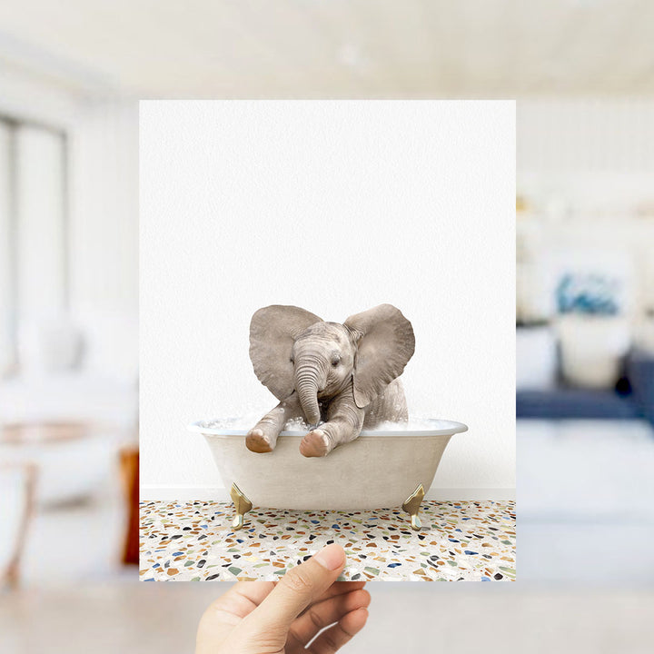 A baby elephant sitting in a bathtub filled with water, surrounded by a colorful mosaic floor.