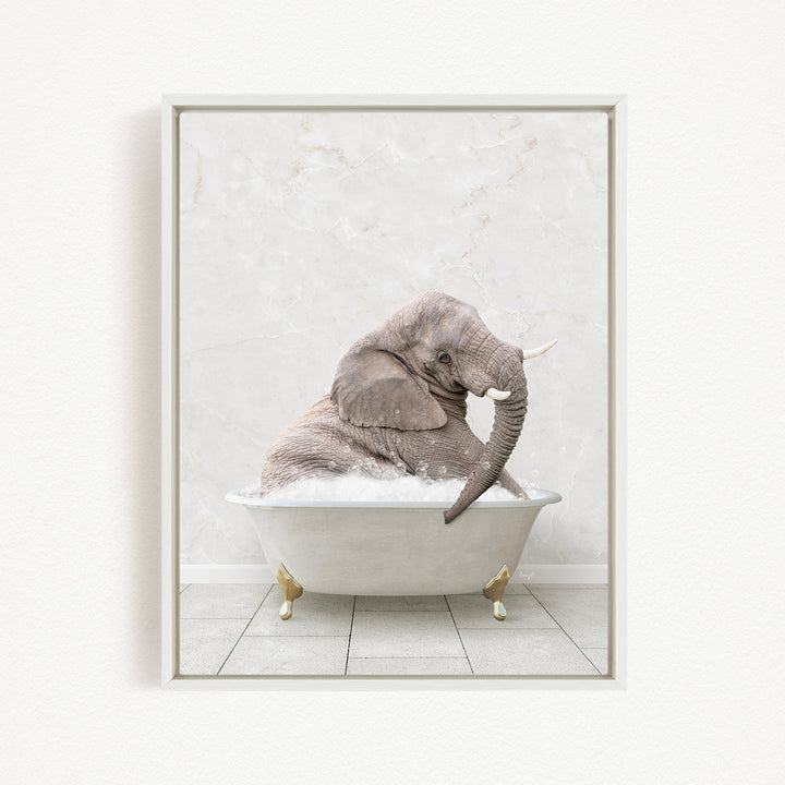 A gray elephant is sitting in a white bathtub filled with water, with its trunk submerged in the water.