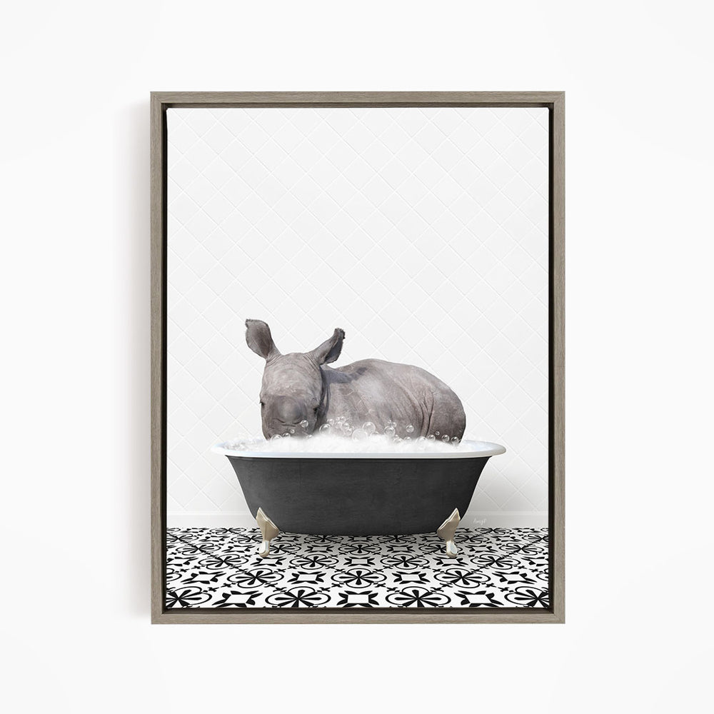 A rhinoceros is sitting in a bathtub filled with water, creating a whimsical and playful scene.