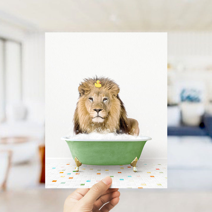 A lion is sitting in a green bathtub filled with bubbles, with a yellow rubber duck floating on its head.