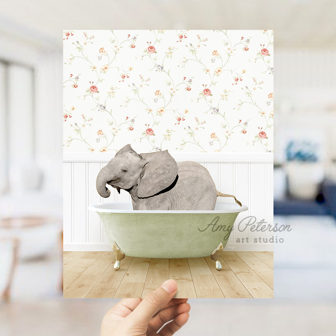 a hand holding up a card with an elephant in a bathtub