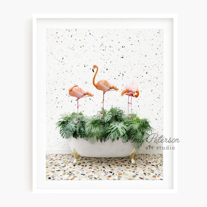 three pink flamingos are standing in a planter