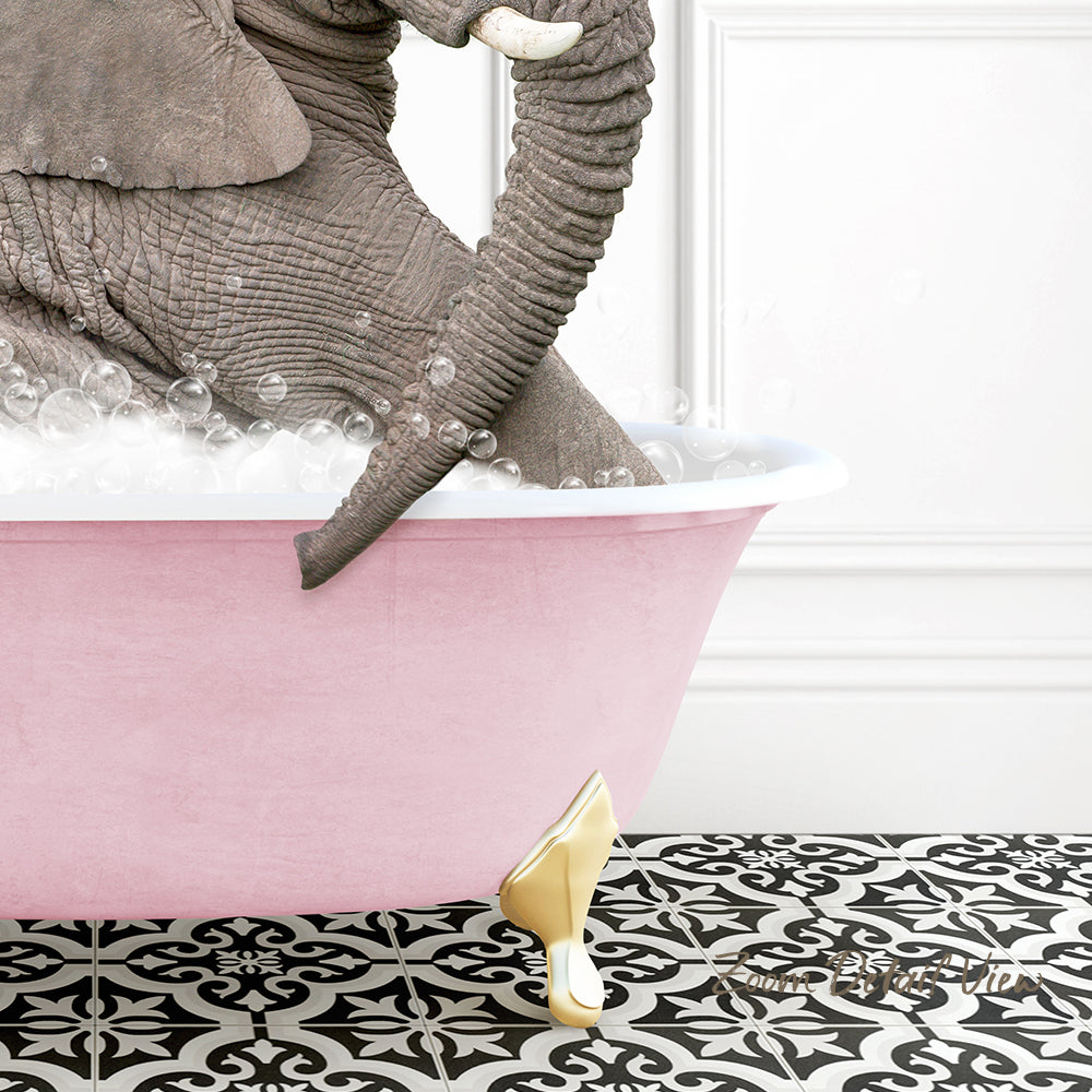 A large gray elephant is sitting in a pink bathtub filled with bubbles, with a gold-colored bathtub faucet and gold-colored bathtub feet visible.