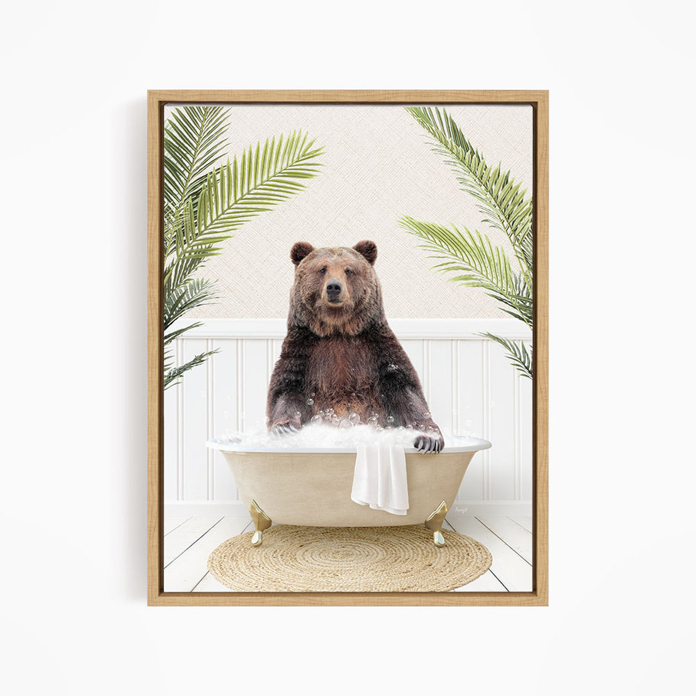 A brown bear sitting in a white bathtub filled with water, surrounded by green palm leaves.