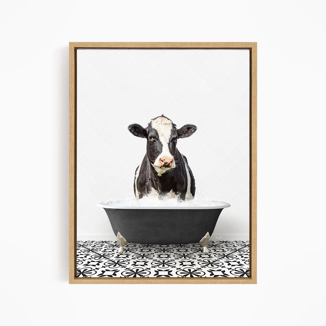A black and white cow is standing in a bathtub filled with water, creating a whimsical and humorous scene.