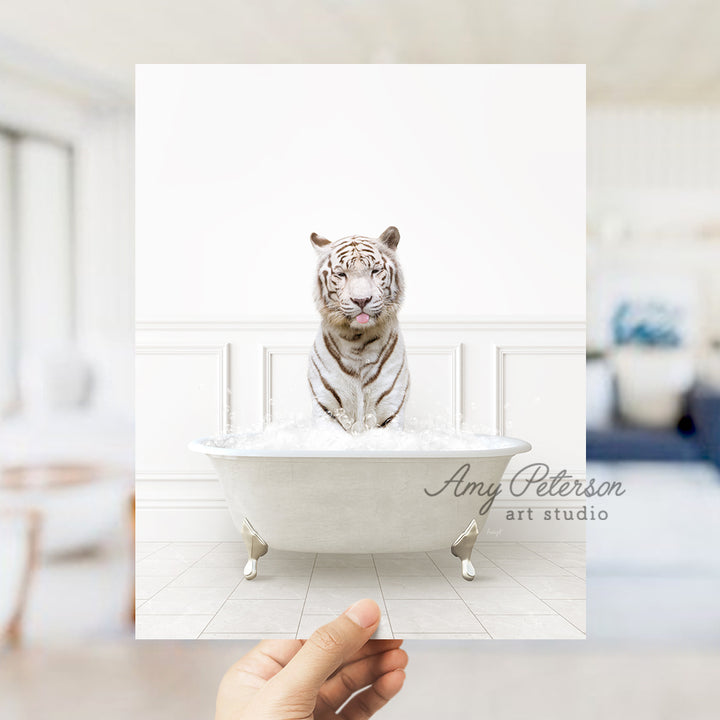 a hand holding a card with a white tiger in a bathtub