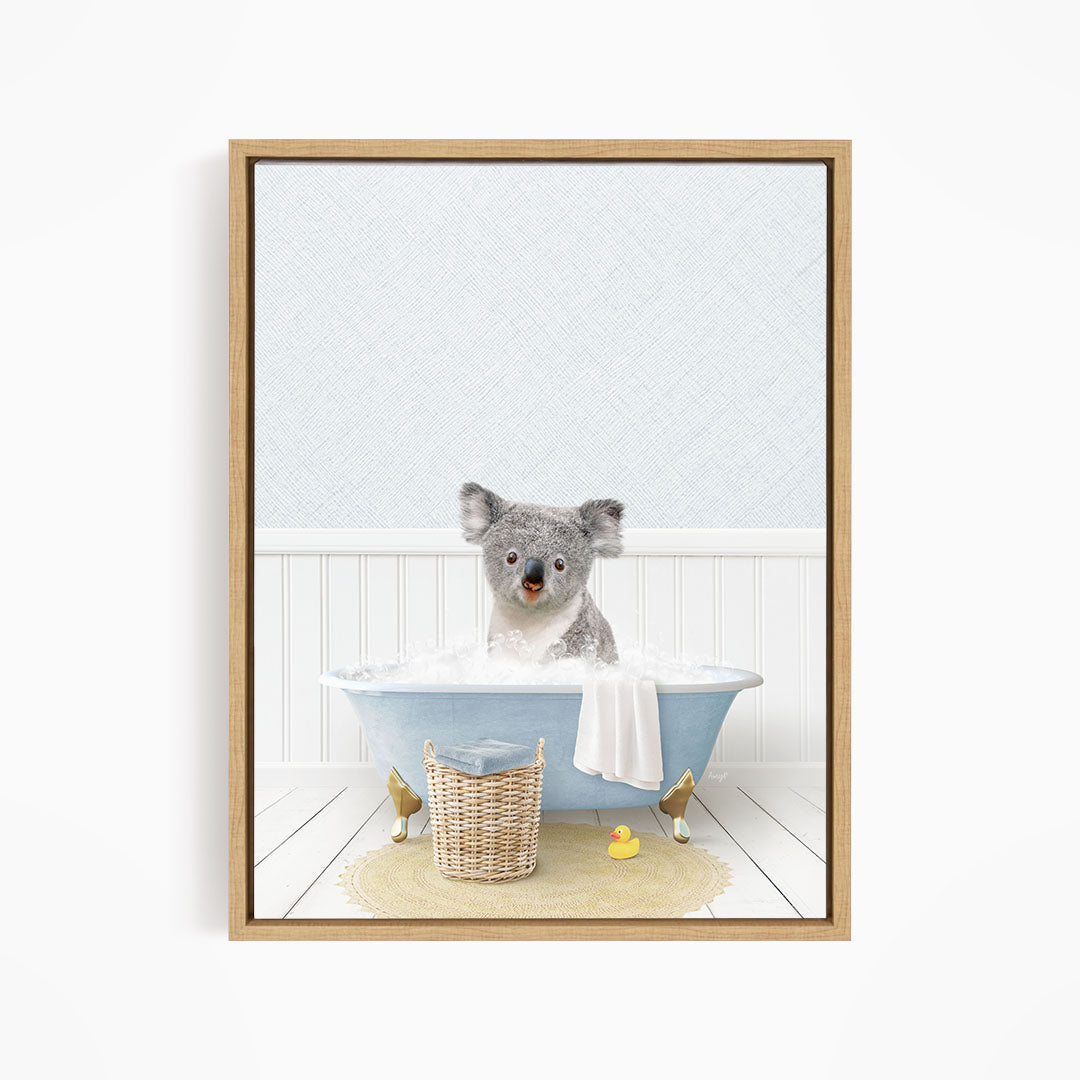 A koala bear sitting in a blue bathtub filled with water, surrounded by rubber ducks.