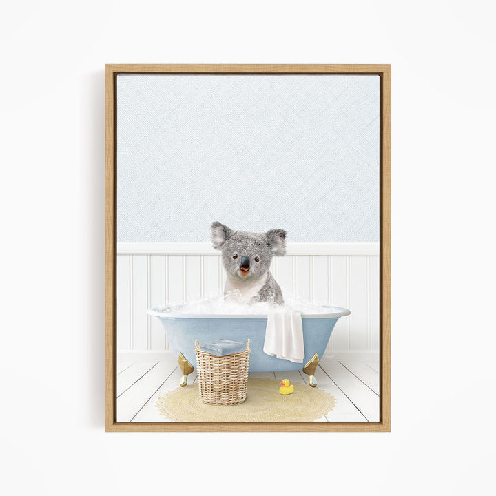 A koala bear sitting in a blue bathtub filled with water, surrounded by rubber ducks.