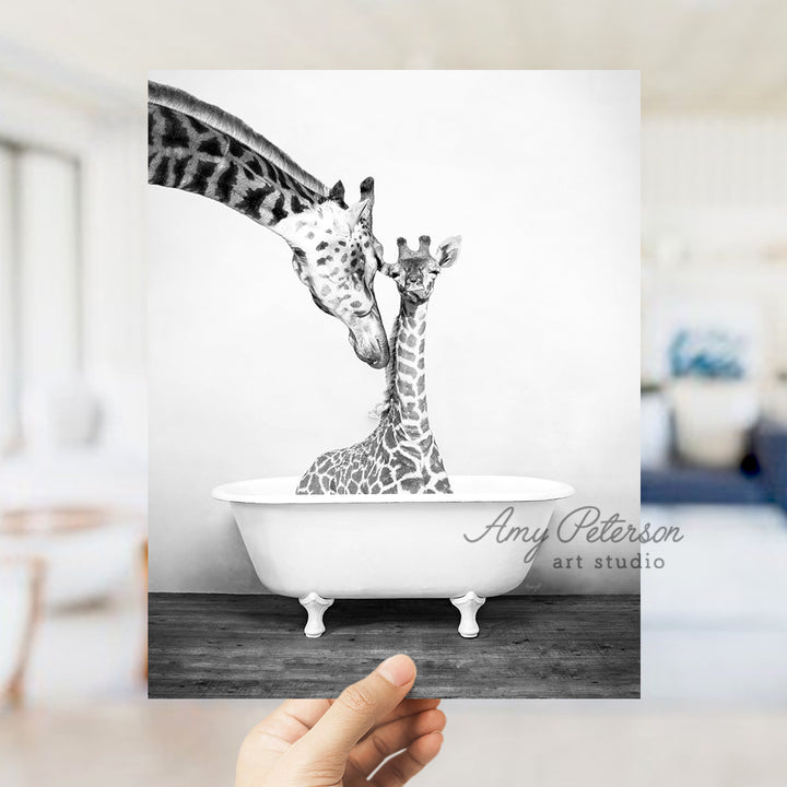 a black and white photo of two giraffes in a bathtub