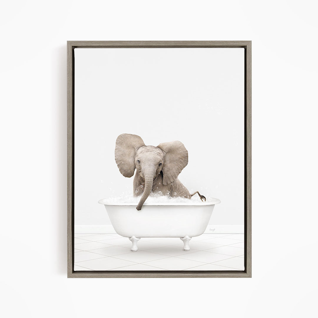 A baby elephant sitting in a white bathtub filled with water, with its trunk submerged in the water.