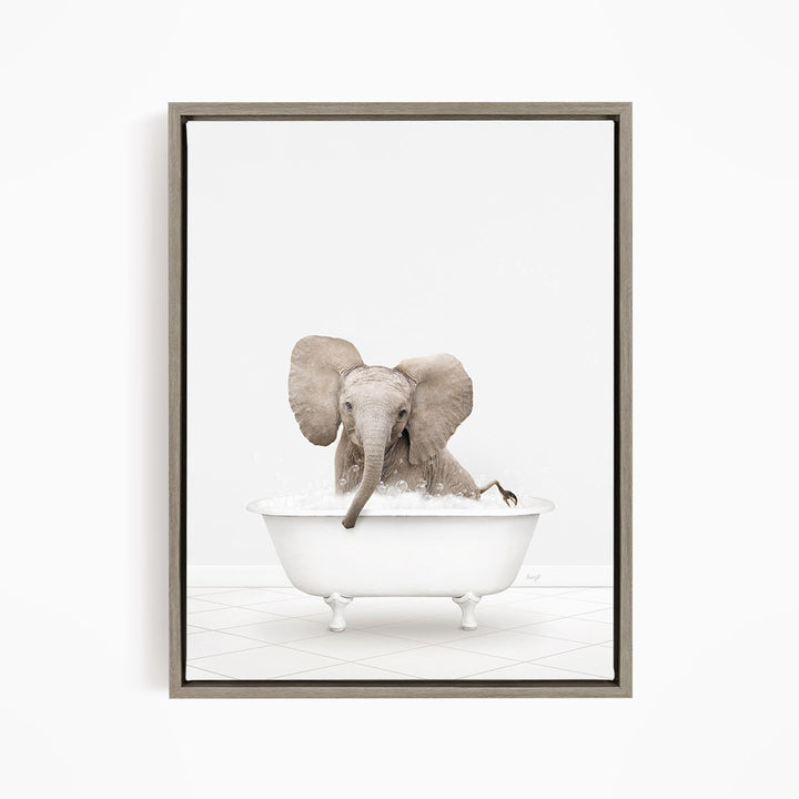 A baby elephant sitting in a white bathtub filled with water, with its trunk submerged in the water.