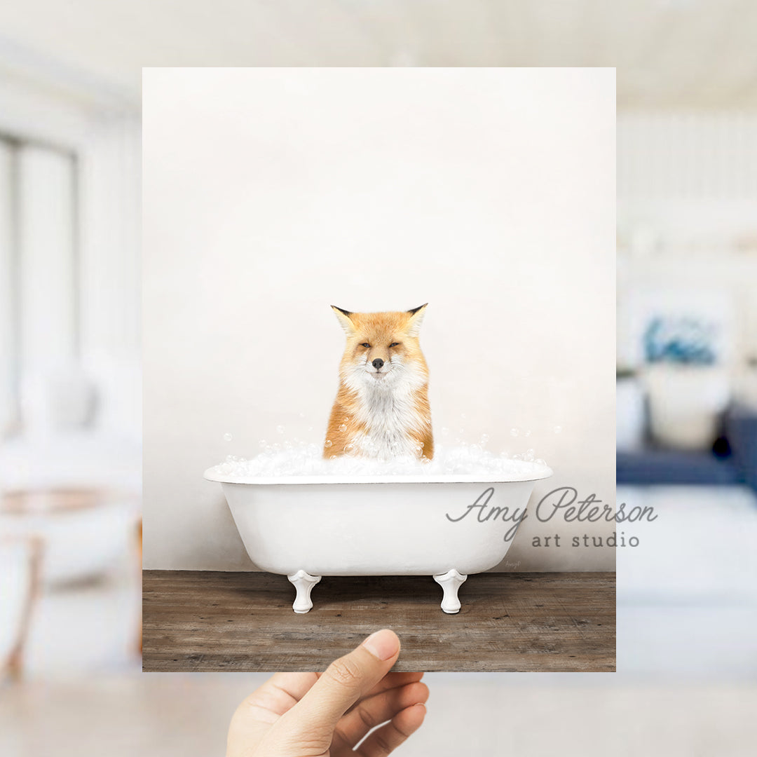 a hand holding up a card with a picture of a fox in a bathtub