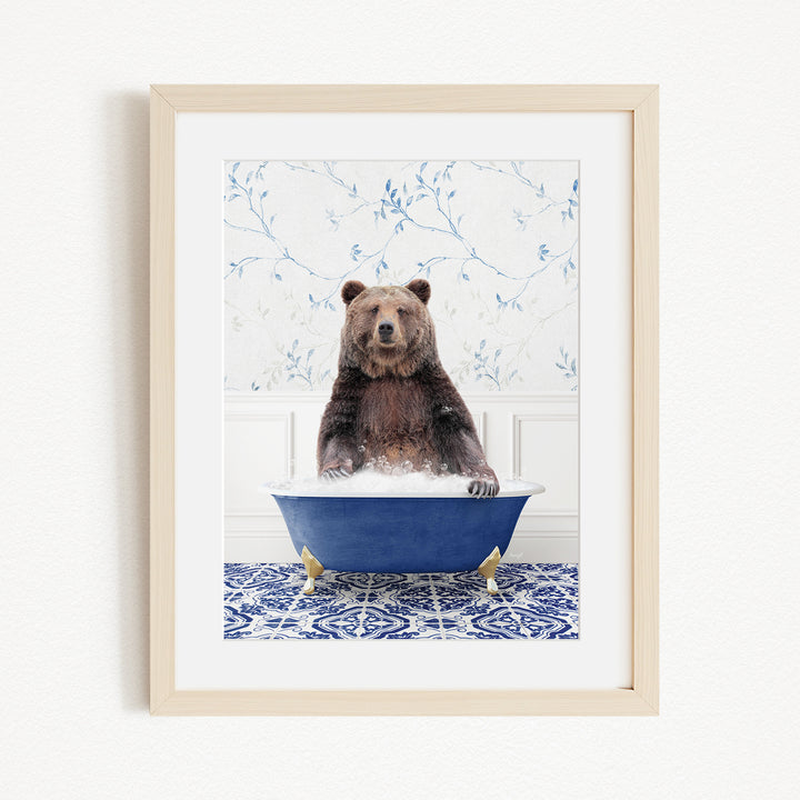 A brown bear sitting in a blue bathtub, surrounded by a blue and white floral patterned wall.
