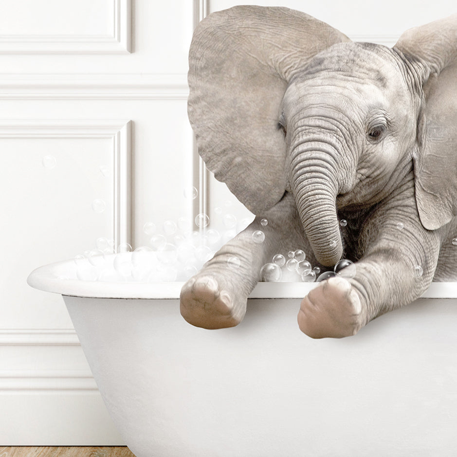 a baby elephant taking a bath in a bathtub