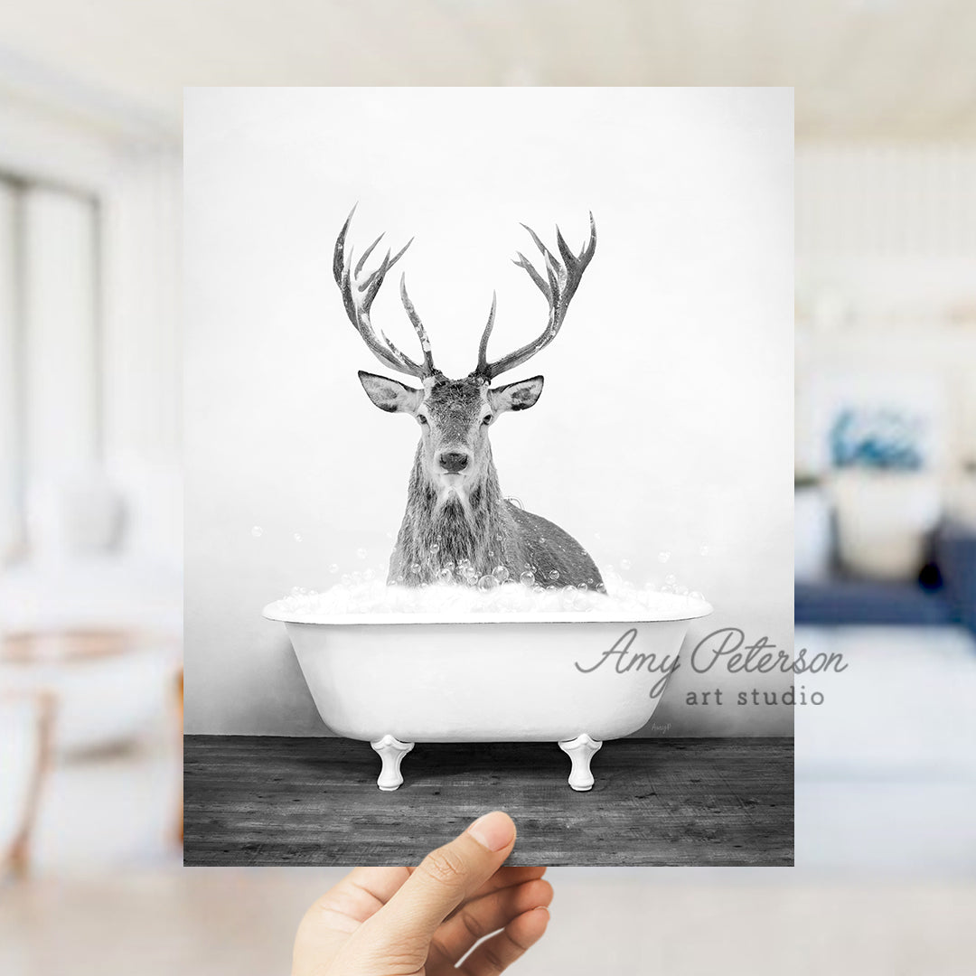 a person holding up a card with a picture of a deer in a bathtub