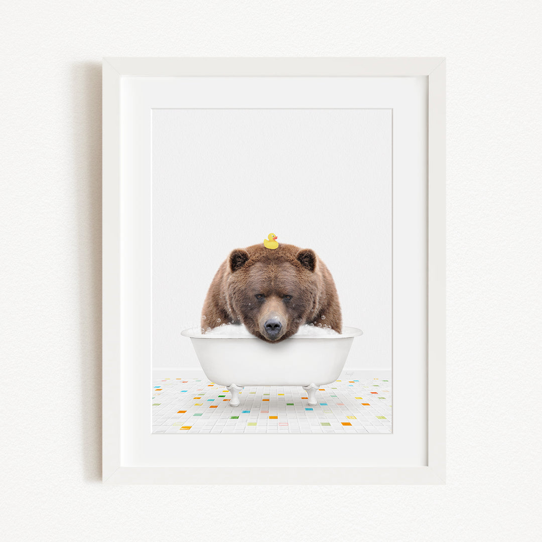 A brown bear is sitting in a white bathtub, with a yellow rubber duck perched on its head.