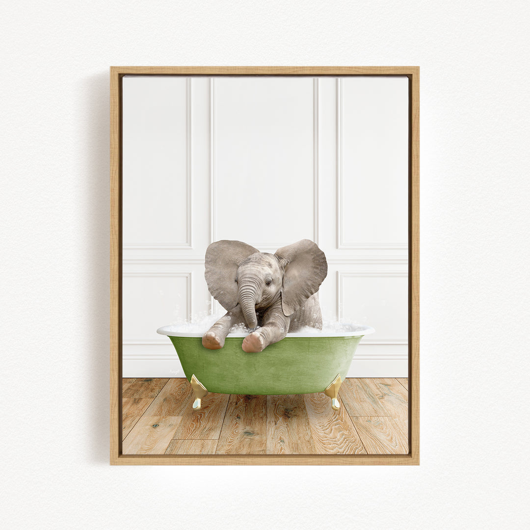 A baby elephant sitting in a green bathtub filled with water, with its trunk submerged in the water.