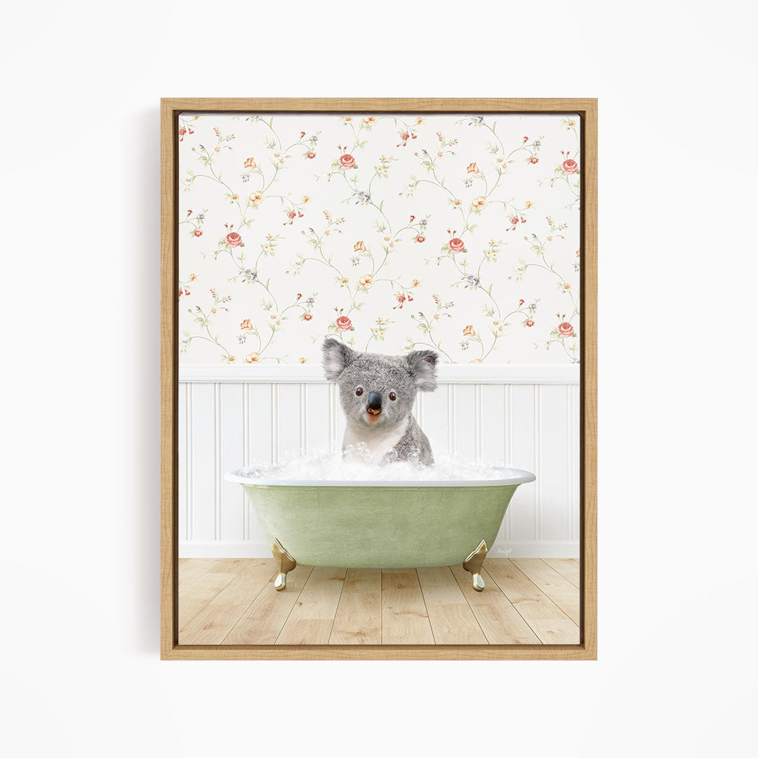 A koala bear sitting in a green bathtub filled with water, with a floral wallpaper in the background.