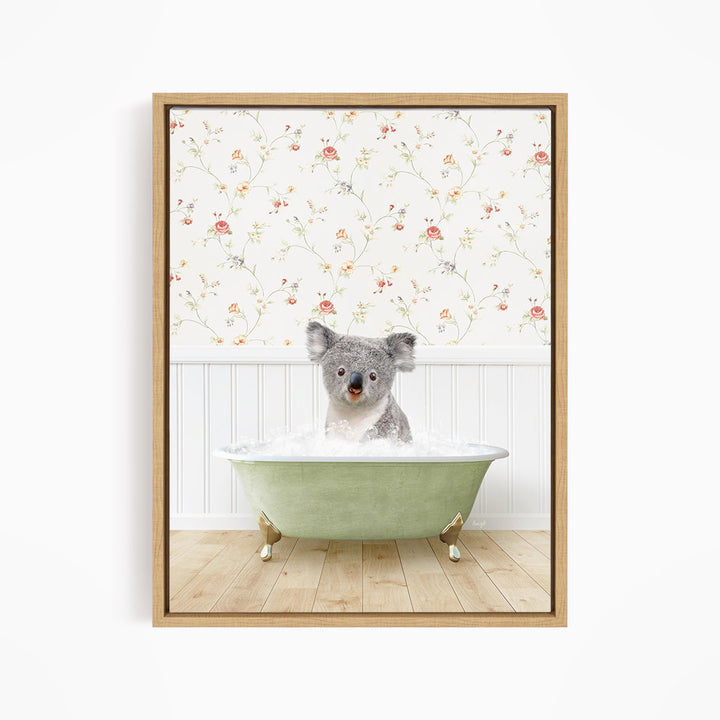 A koala bear sitting in a green bathtub filled with water, with a floral wallpaper in the background.