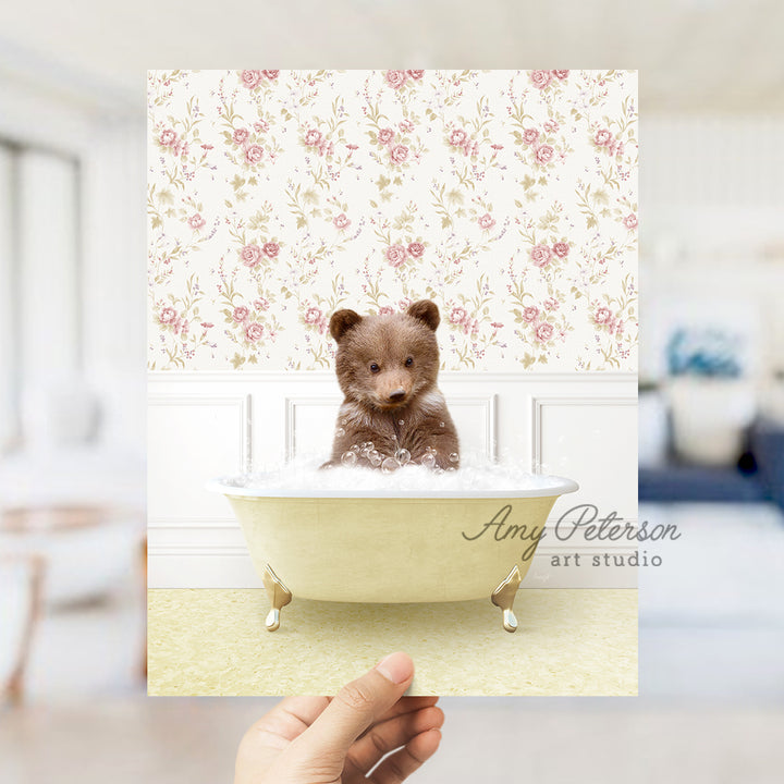 a person holding up a card with a teddy bear in a bathtub