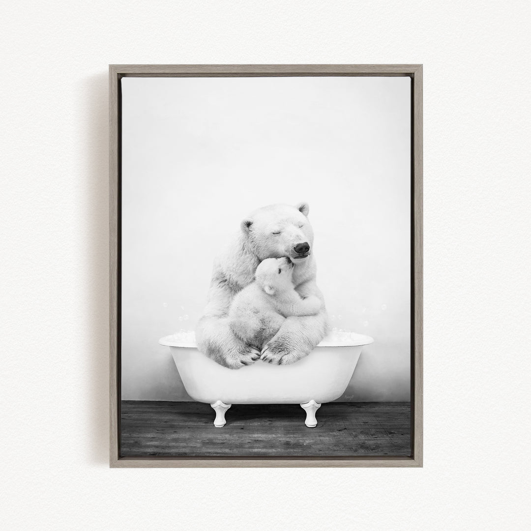 A black and white photograph of a mother polar bear sitting in a bathtub, holding her cub.