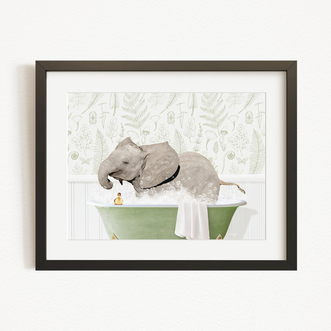 A framed image depicting an elephant sitting in a green bathtub, with a person standing next to it.