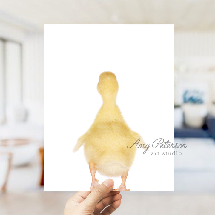 a person holding up a picture of a duck