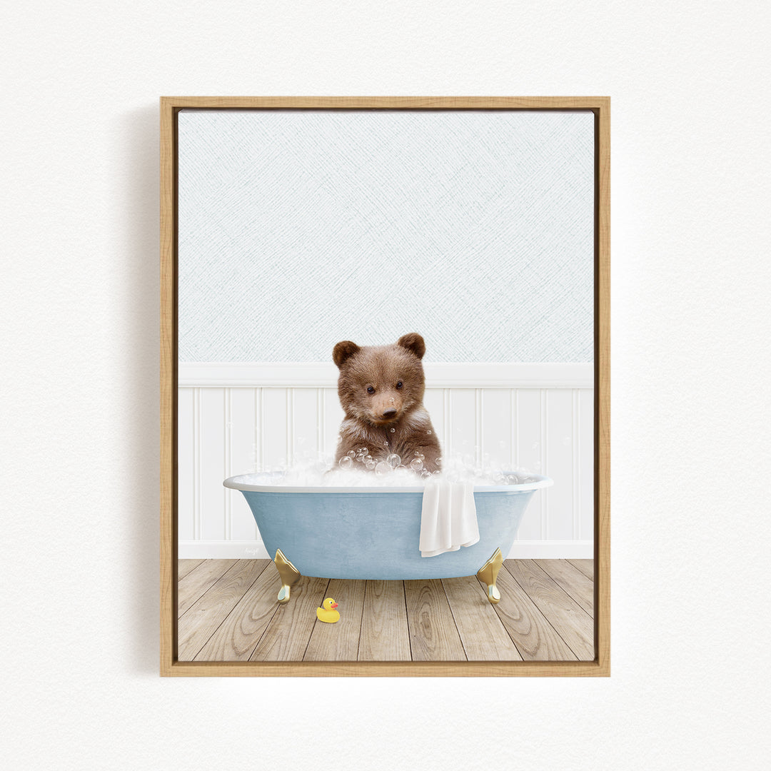A cute brown bear sitting in a blue bathtub filled with bubbles, surrounded by a white background.