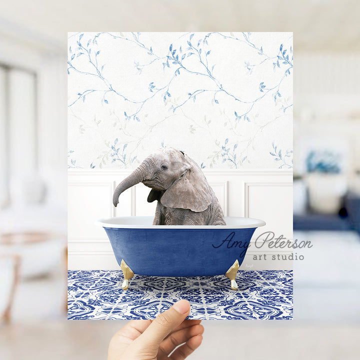 a person holding up a card with a picture of an elephant in a bathtub