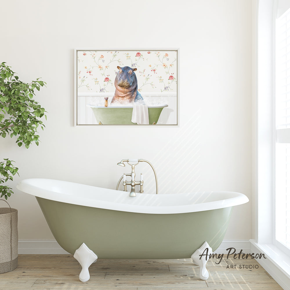 A green clawfoot bathtub with a framed picture of a hippopotamus sitting in it on the wall above it.