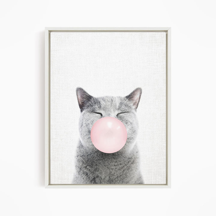 A gray cat with its eyes closed and a pink bubble blowing in its mouth.