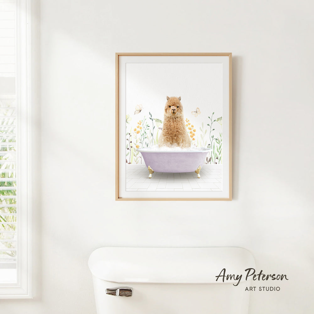 A framed illustration of a dog sitting in a bathtub, surrounded by flowers and butterflies, is hanging on a white wall.