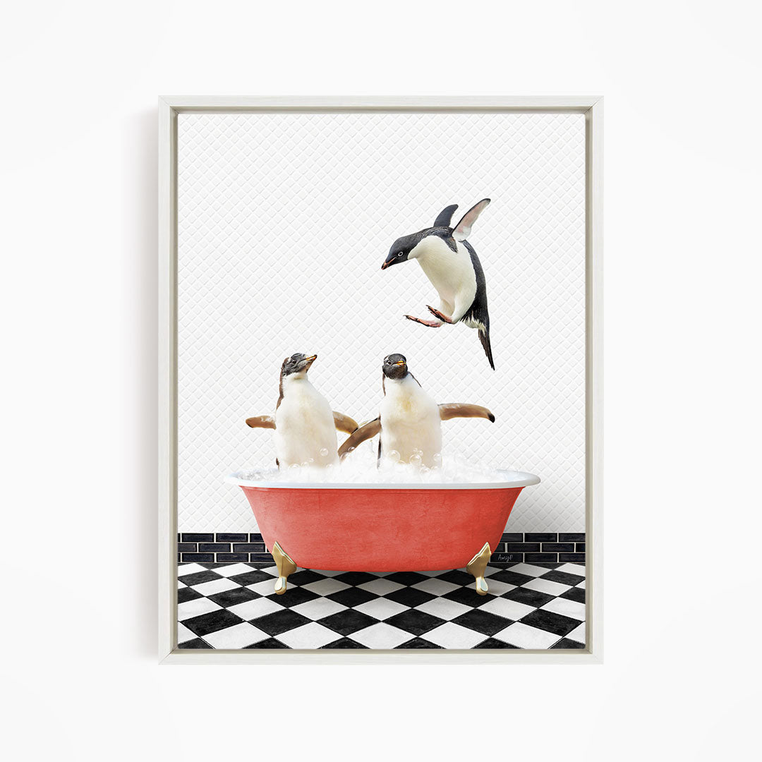 A framed image depicting two penguins standing in a red bathtub filled with water, with one penguin flying towards the other.