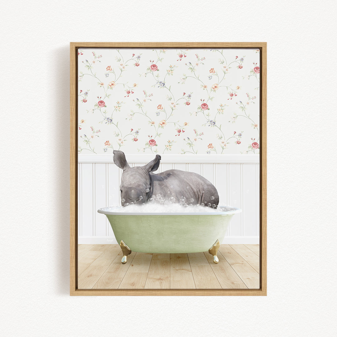 A rhinoceros is sitting in a green bathtub filled with water, surrounded by a floral wallpaper.