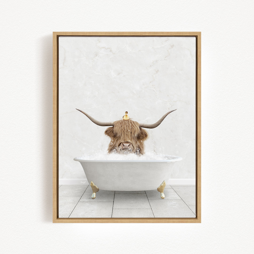 A framed image depicting a cow with long horns sitting in a white bathtub, with a small bird perched on its head.