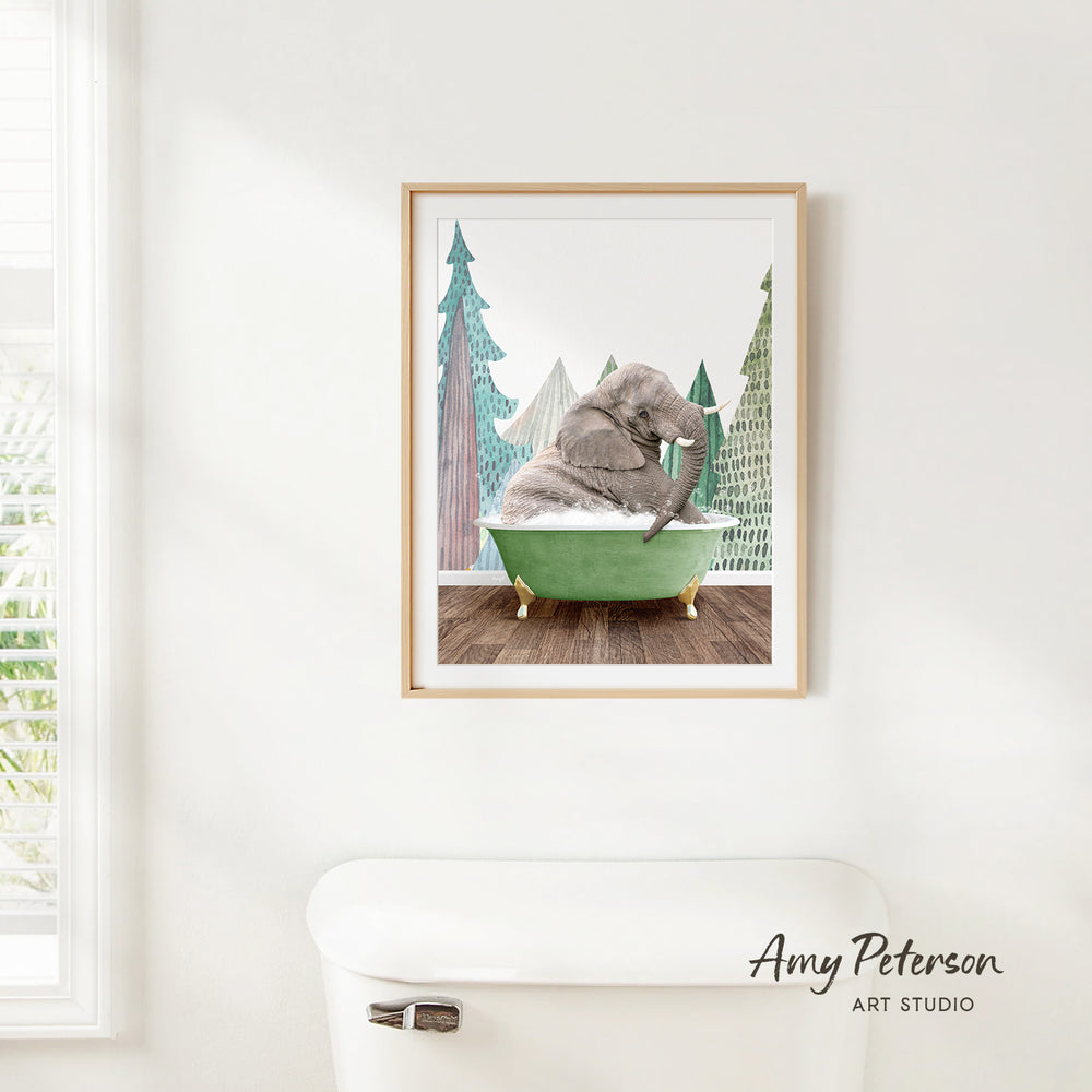 A framed illustration of an elephant sitting in a green bathtub, surrounded by trees and a snowy landscape.