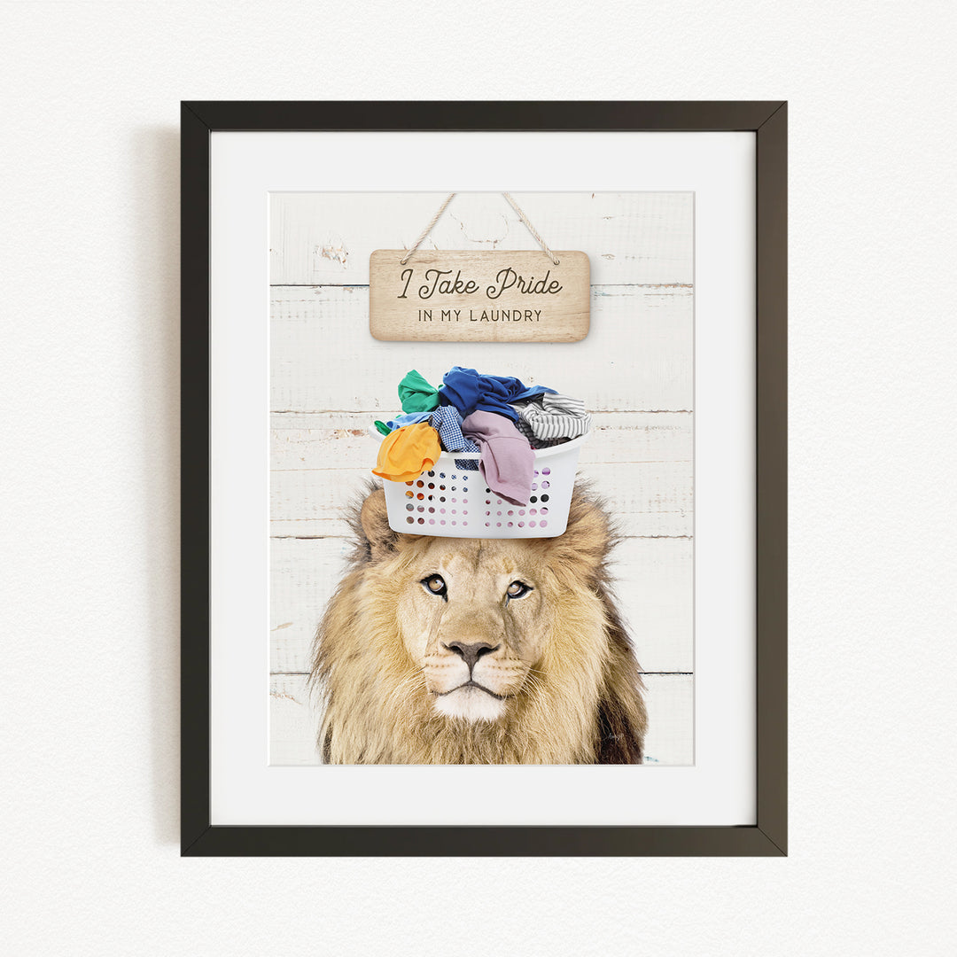 A framed image of a lion wearing a basket of laundry, with a sign above that says "I Take Pride in My Laundry".