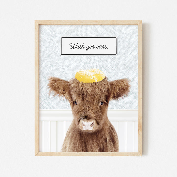 a picture of a brown cow with a yellow hat on its head