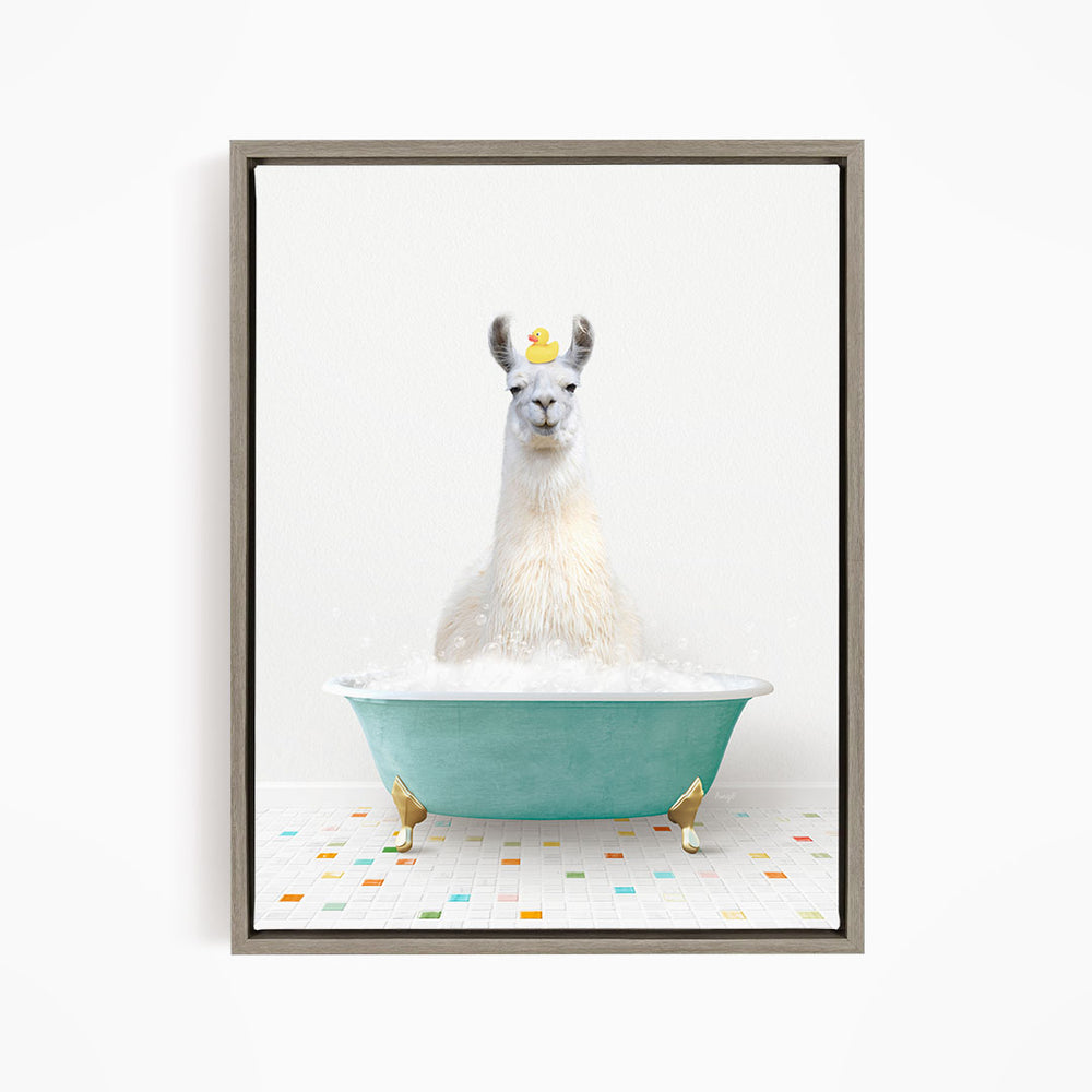 A white llama sitting in a green bathtub filled with bubbles, with a yellow rubber duck floating on its head.