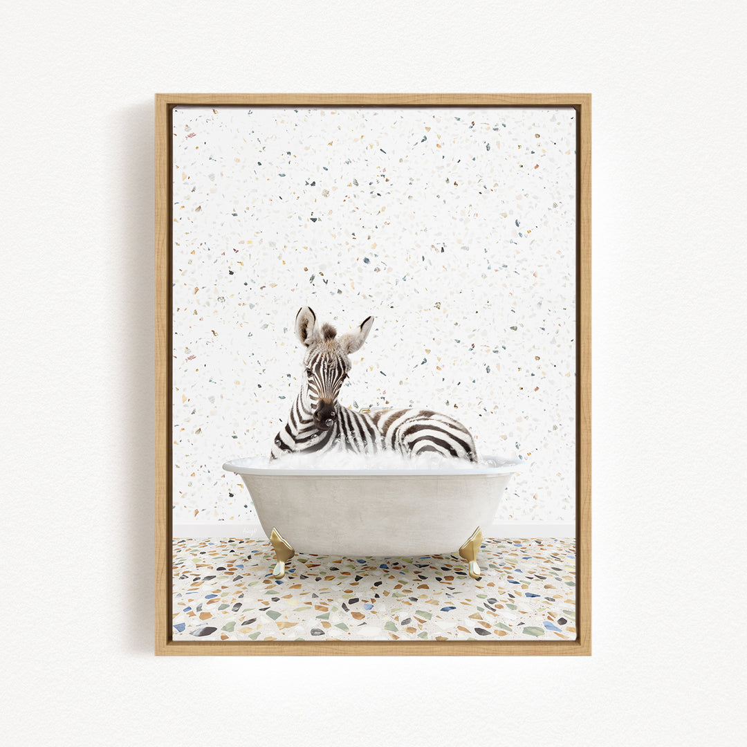 A zebra is sitting in a white bathtub, surrounded by a speckled background.