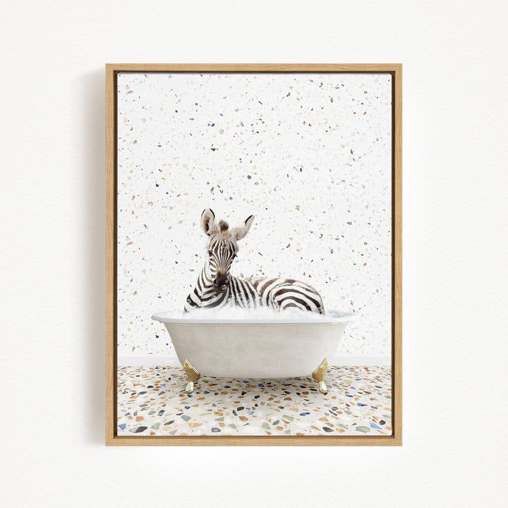 A zebra is sitting in a white bathtub, surrounded by a speckled background.