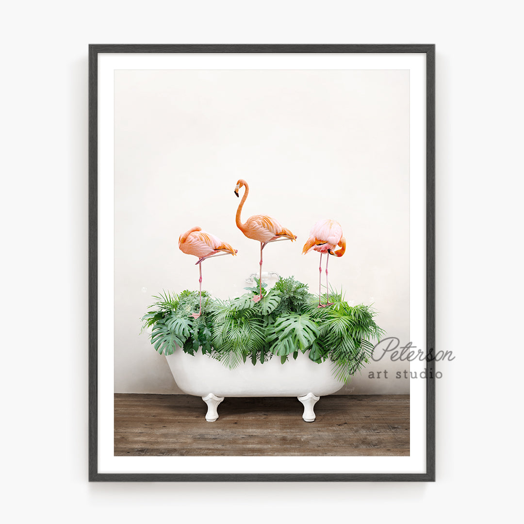 three flamingos in a bathtub with plants in it