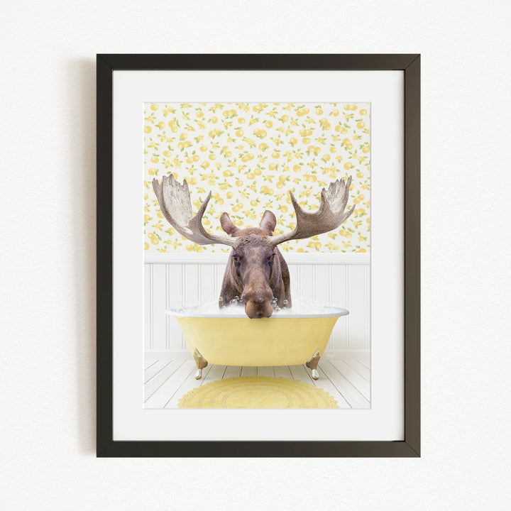 A moose with large antlers is sitting in a yellow bathtub, surrounded by a yellow floral pattern on the wall behind it.