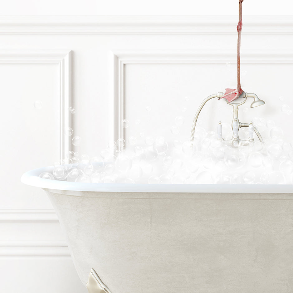 a bathtub filled with white foam and a pink flower