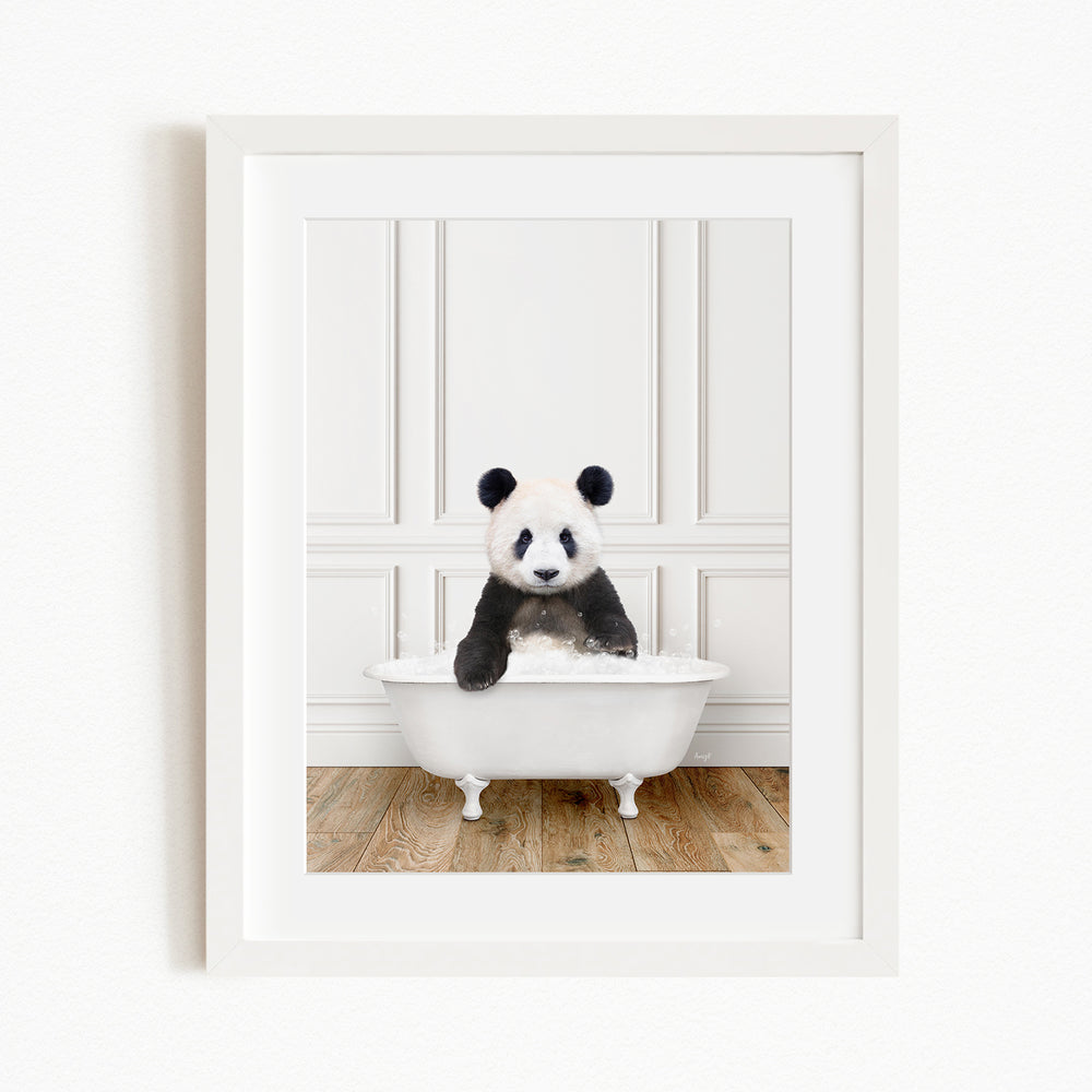 A panda bear sitting in a white bathtub, surrounded by a white wall and wooden floor.