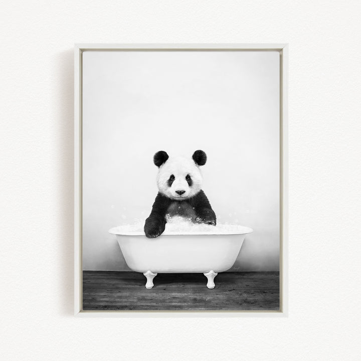 A panda bear sitting in a white bathtub filled with bubbles, creating a whimsical and playful scene.