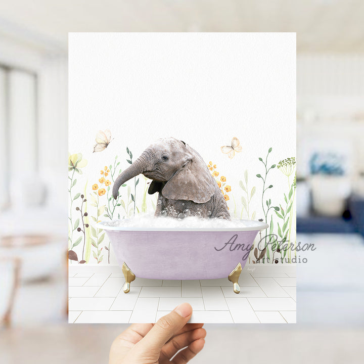 a person holding up a card with a picture of an elephant in a bathtub