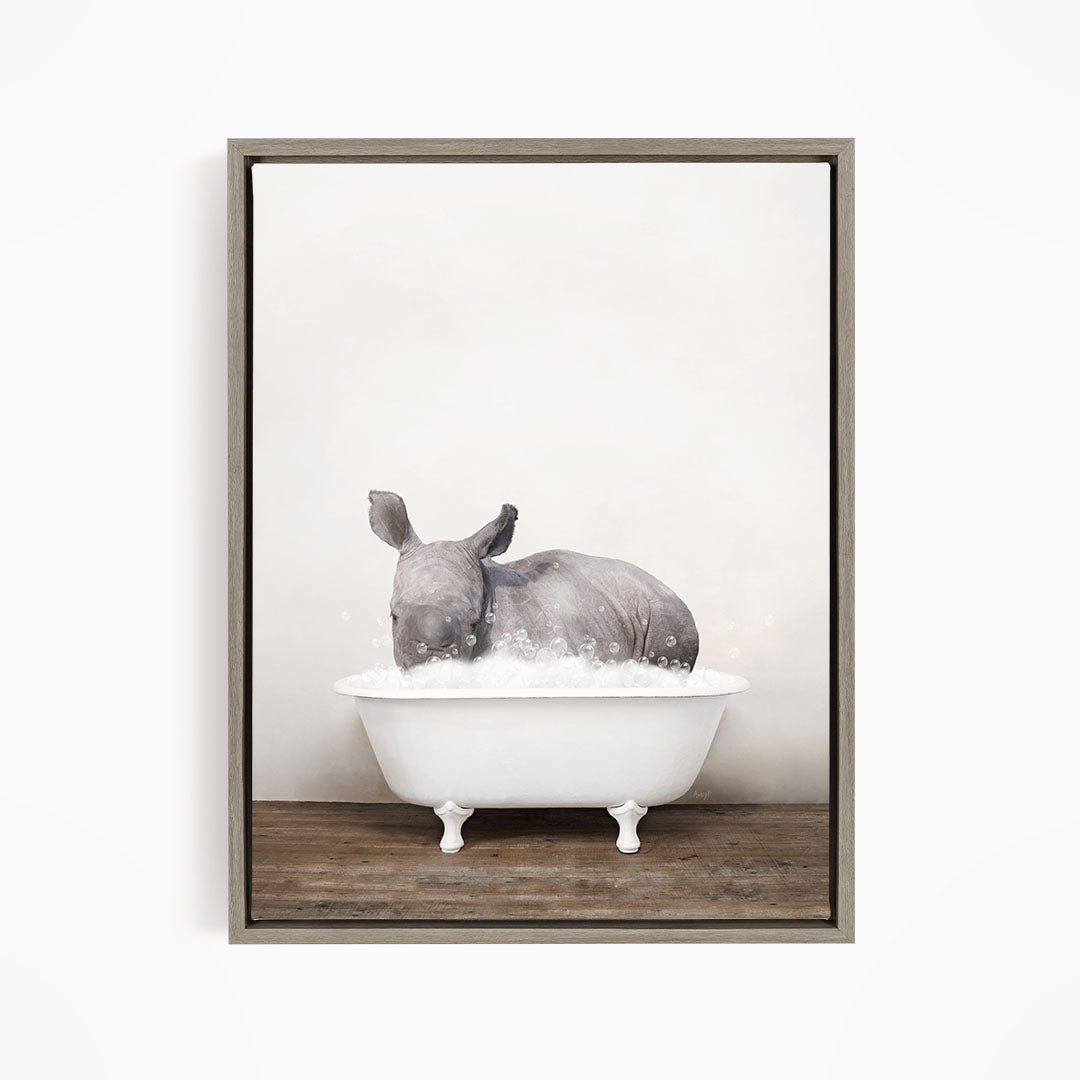 A rhinoceros is sitting in a white bathtub filled with water, creating a whimsical and playful scene.